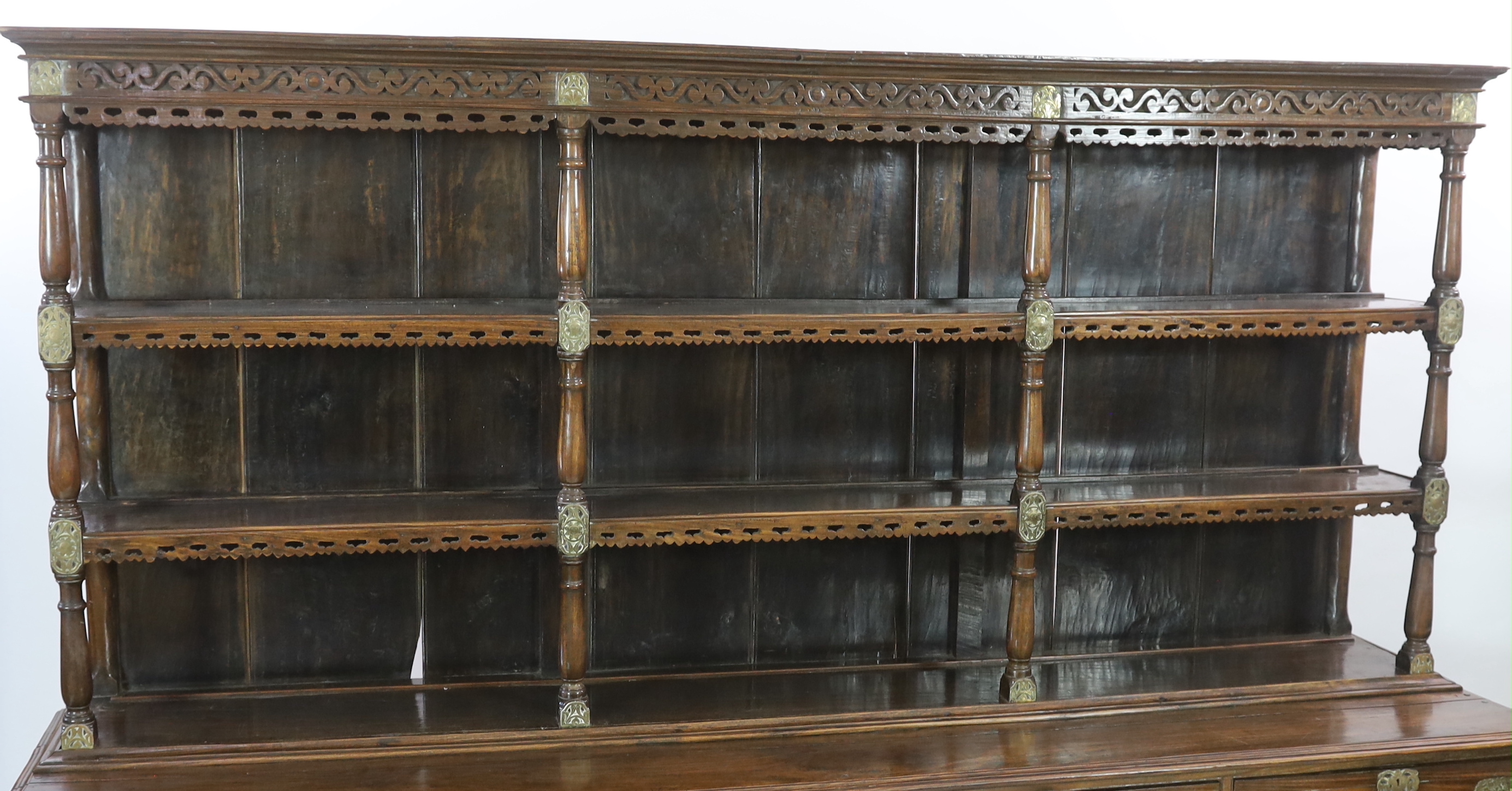 A rare Ceylonese Arts & Crafts brass mounted teak dresser